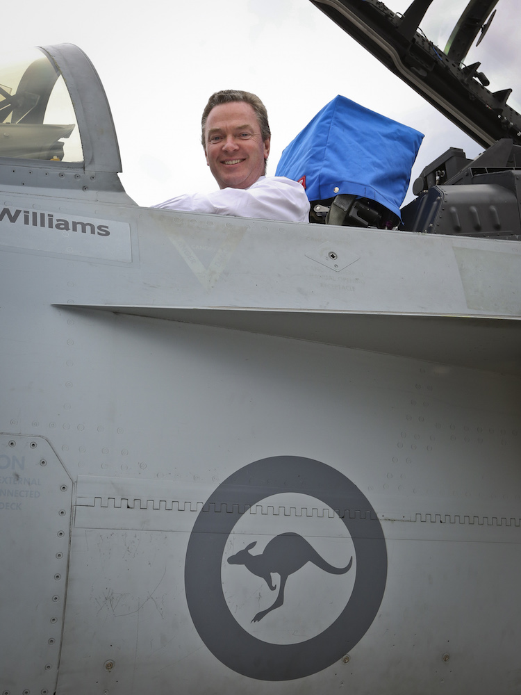 The Honorable Christopher Pyne MP, Minister for Defence Industry sits in the cockpit of an F/A-18F Super Hornet during his visit to RAAF Base Amberley.
