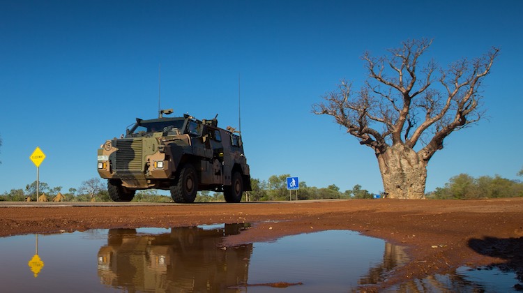 An Australian Army Bushmaster protected mobility vehicle from 1st Brigade drives along the Great Northern Highway during Exercise Northern Shield 2016.