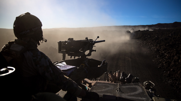 An Australian Army soldier from 2nd Cavalry Regiment ensures his ASLAV (Australian Light-Armoured Vehicles) follows the convoy as it moves through Pohakuloa training area, Hawaii, during Exercise Rim of the Pacific on 17 July 2016.