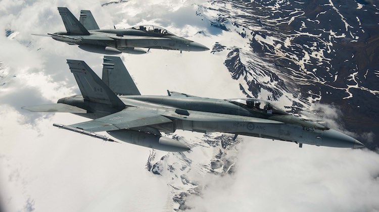 Two Royal Canadian Air Force CF-188 Hornet fighters from 433 Tactical Fighter Squadron fly over Iceland on May 31, 2017 during an Operation REASSURANCE surveillance mission. Photo: Corporal Gary Calvé. Imagery Technician ATF-ICELAND RP09-2017-0025-005 ~ Deux chasseurs CF-188 Hornet du 433e Escadron d’appui tactique de l’Aviation royale canadienne survolent l’Islande, le 31 mai 2017, lors d’une mission de surveillance au cours de l’opération REASSURANCE. Photo : Caporal Gary Calvé. Technicien en imagerie, FOA-ISLANDE RP09-2017-0025-005