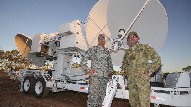 After the safe arrival and positioning of the United States Air Force Joint Threat Emitter at Bradshaw Field Training Area in the Northern Territory, Technical Sergeant Phil Mason and Royal Australian Air Force Flight Lieutenant Matt Rush pause and relax for a moment. *** Local Caption *** Exercise Diamond Storm, run by the Air Warfare Centre, is one of the practical components of the Air Warfare Instructors Course which graduates students who are experts in Australian Defence Force capabilities and integration across the services, and also have technical mastery of their own roles, capabilities and systems.
